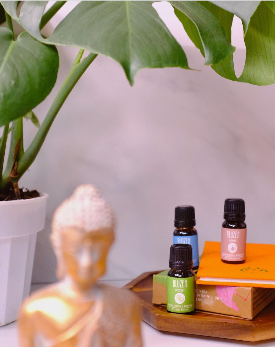 A table with aromatherapy essential oils and a candle